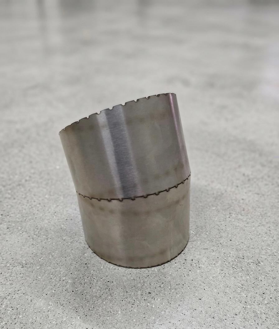 Angled stainless steel elbow tube section with a scalloped laser-cut seam